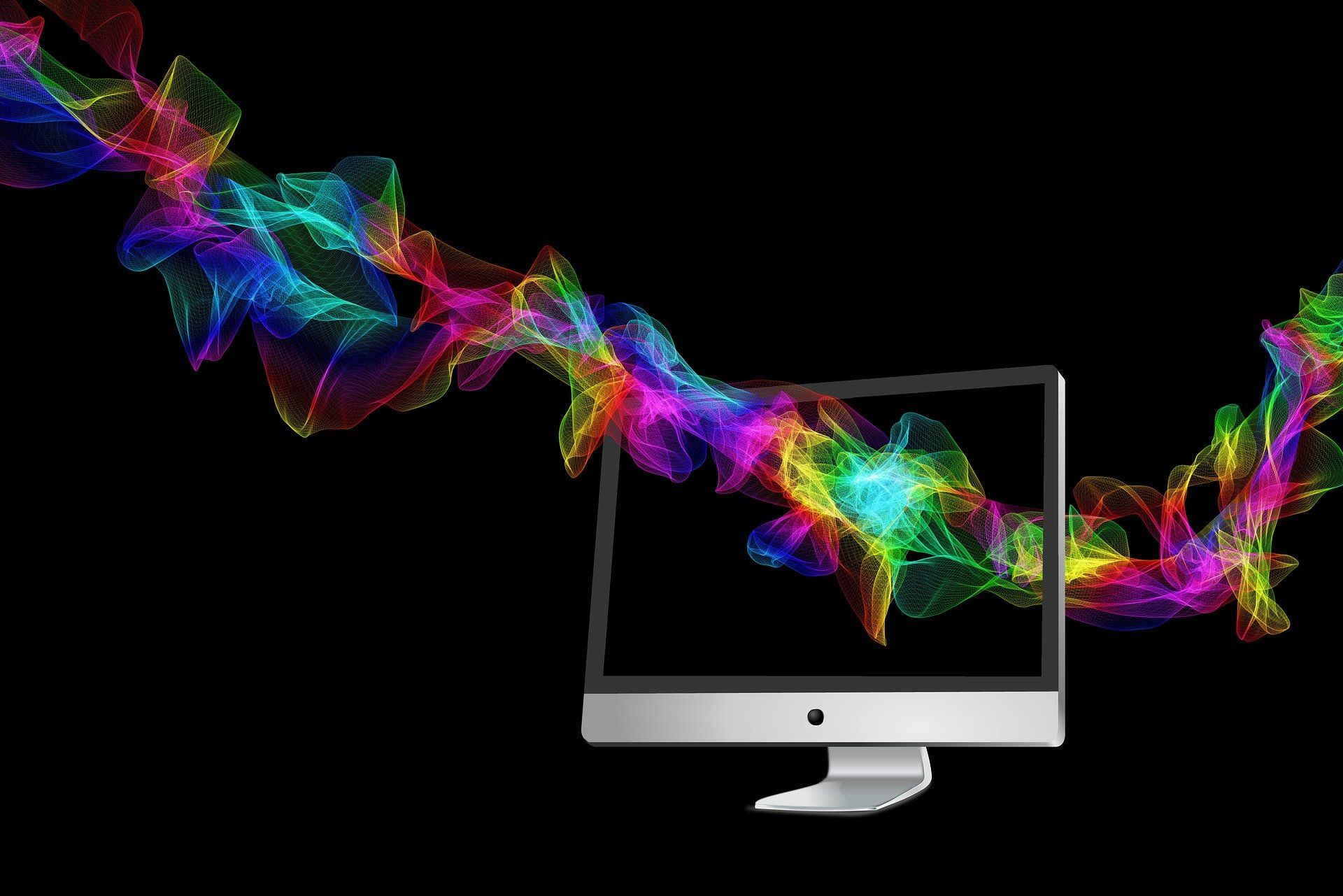 sombras coloridas passam por um monitor de computador, representando a criatividade do design de serviços
